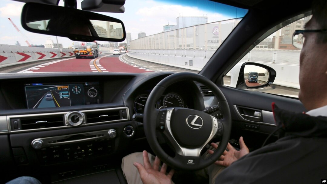 FILE - An employee of Toyota Motor Corp., drives automated driving test vehicle during a test drive of Toyota's self-driving technologies in Tokyo. Such cars are one field in which researchers are seeking to expand the limits of machine learning.