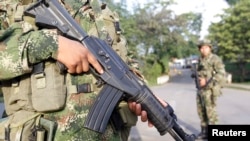 Colombian soldiers stand guard on a street in Caloto, Columbia, Feb. 6, 2014.