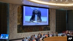 In this UN photo, Marcel Utembi, on screen, president of the National Episcopal Conference of the Congo, addresses the Security Council on the situation concerning the Democratic Republic of the Congo, Aug. 27, 2018.
