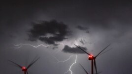 In this Aug. 1, 2017 photo lightning illuminate the night sky over the Odervorland wind farm in the Oder-Spree district near to Sieversdorf, Germany. (Patrick Pleul/dpa via AP)