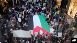 FILE - Palestinian supporters march through central Sydney, Oct. 9, 2023. Hundreds of pro-Palestinian protesters gathered at the Sydney Opera House, which was planned to be illuminated in the colors of the Israeli flag, but police advised the Jewish community to stay away. 