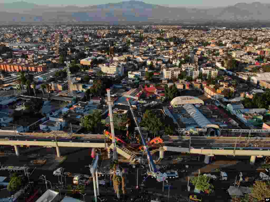 An aerial view shows subway cars dangling from the tracks after a collapse of the elevated section of the metro, in Mexico City, killing at least 23 people and injuring at least 79.