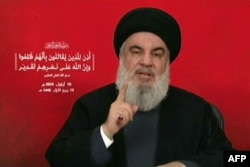 FILE - An image taken from Hezbollah's Al-Manar TV shows the Lebanese militant group's chief, Hassan Nasrallah, addressing the nation from an undisclosed location on Sept. 19, 2024.