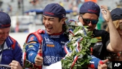Takuma Sato, of Japan, celebrates on the start/finish line after winning the Indianapolis 500 auto race at Indianapolis Motor Speedway, May 28, 2017 in Indianapolis, Indiana.