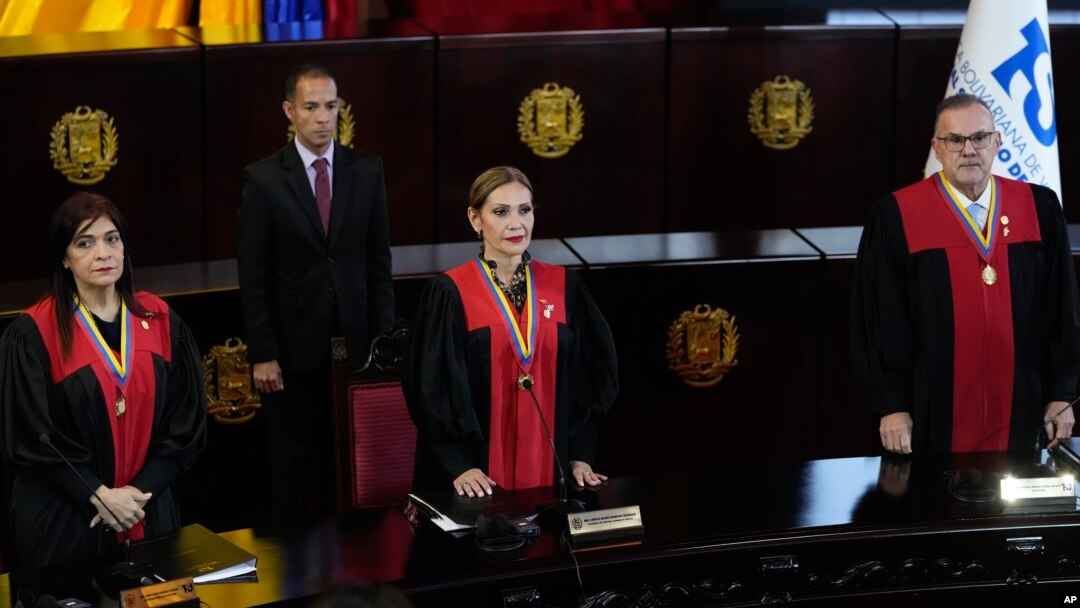 Los jueces de la Corte Suprema, de izquierda a derecha, Fanny Márquez, la presidenta Caryslia Rodríguez e Inocencio Figueroa, de pie durante una ceremonia posterior a la auditoría de la Corte de los resultados controvertidos de las elecciones presidenciales en Caracas, Venezuela.