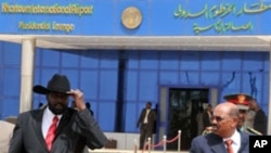 Sudanese President Omar al-Bashir (R) walks with Sudan's First Vice President and south Sudan leader Salva Kiir at the airport in Khartoum, as he prepares to leave for Chad, 21 Jul 2010