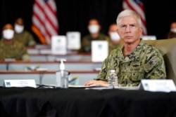 FILE - U.S. Navy Adm. Craig Faller listens during a briefing at U.S. Southern Command, in Doral, Fla., July 10, 2020.