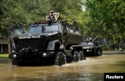 Houston police vehicles move through Harvey floodwaters in Houston, Texas, Sept. 1, 2017.