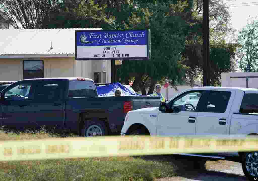 Law enforcement officers work in front of the First Baptist Church of Sutherland Springs after a fatal shooting, Nov. 5, 2017, in Sutherland Springs, Texas.