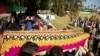 FILE - Relatives carry a casket with the body of journalist Malala Maiwand, who was shot and killed by gunmen, during her funeral in Jalalabad, east of Kabul, Afghanistan, Dec. 10, 2020.