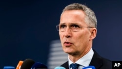 NATO Secretary-General Jens Stoltenberg talks with journalists as he arrives for a meeting of EU foreign and defense ministers at the Europa building in Brussels, May 18, 2017.