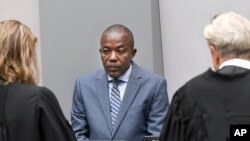 Alfred Yekatom, center, a Central African Republic lawmaker and militia leader who goes by the nickname Rambo, appears before the International Criminal Court, ICC, in The Hague, Netherlands, Nov. 23, 2018. 