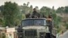 FILE - Government soldiers ride in the back of a truck, in Ethiopia, May 11, 2021.