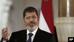 Egyptian President Mohammed Morsi speaks to reporters after meeting Tunisian President Moncef Marzouki in Cairo, Friday, July 13.