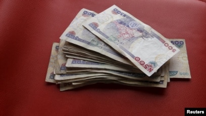 Nigeria Devalues Its Currency As Recession Looms File Nigerian Naira Notes Are Seen In This Picture Ilration March 15 2016
