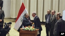 Iraq's President Jalal Talabani, center left, shakes hands with Osama al-Nujeifi, center right, the elected parliament speaker during a Parliament session in Baghdad, Iraq, Thursday, Nov. 11, 2010. Iraq's president gave Shiite Prime Minister Nouri al-Mali