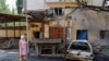 FILE - A woman walks at a site of a recent shelling, which local Russian-installed authorities called a Ukrainian military strike, in the course of Russia-Ukraine conflict in Donetsk, Russian-controlled Ukraine, July 22, 2024.