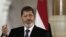 Egyptian President Mohammed Morsi, speaks with reporters in Cairo, July 13, 2012.