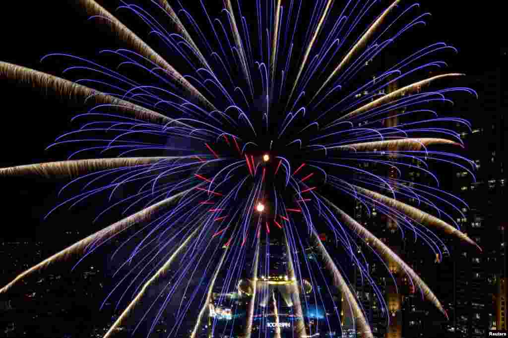Fireworks explode over Chao Phraya River during the New Year celebrations in Bangkok, Thailand, Jan. 1, 2021.