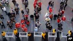 People wait to go through security at the T-Mobile arena before an NHL hockey game in Las Vegas, Nevada, Oct. 13, 2017. The city's tourism sector is bracing for changes in the aftermath of the massacre that killed 58 people at an outdoor music festival.