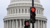 A stoplight is seen in front of the dome of the US Capitol as a government shut down looms in Washington, DC, on September 28, 2023.