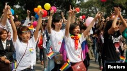 Participants take part in a flash mob during a lesbian, gay, bisexual, and transgender (LGBT) event on a street in Hanoi, Oct. 27, 2013.