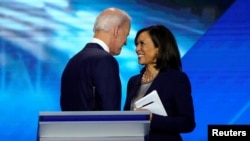 FILE PHOTO: Former Vice President Joe Biden talks with Senator Kamala Harris after the conclusion of the 2020 Democratic U.S. presidential debate in Houston, Texas, U.S., September 12, 2019. REUTERS/Mike Blake/File Photo