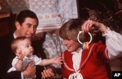 FILE - Princess Diana and Prince Charles are shown with their son Prince William during a photo session at Kensington Palace in London in December 1982.