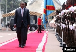 Angola's President Joao Lourenco inspects a guard of honor before meeting Democratic Republic of Congo's President Joseph Kabila in Kinshasa, Democratic Republic of Congo, Feb. 14, 2018.