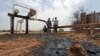 Oil well oozes crude it was hit by bomb shrapnel from fighter jets at El Nar oil field in South Sudan's Unity State, March 3, 2012.