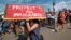 FILE - Supporters of the Deferred Action for Childhood Arrivals, or DACA chant slogans and carry signs while joining rally in downtown Los Angeles, Sept. 4, 2017.