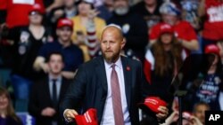 FILE - Brad Parscale, then manager of President Donald Trump's reelection campaign, throws "Make America Great Again" hats to the audience before a rally in Grand Rapids, Michigan, March 28, 2019.