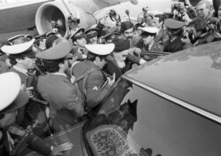 FILE - In this Feb. 1, 1979 file photo, exiled Ayatollah Ruhollah Khomeini has a heavy escort as he enters car to leave the airport in Tehran.