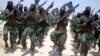 FILE - Members of Somalia's al- Shabab militant group patrol on foot on the outskirts of Mogadishu.