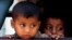FILE - Rohingya minority children look out through a window of a bus after they were rescued by Thai authorities in Songkhla province, southern Thailand.