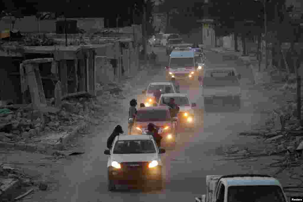 Rebel fighters drive their vehicles celebrating what they said was the takeover from Islamic State of Baraghedeh and Kafr-Ghan towns, northern Aleppo countryside, Syria, Oct.10, 2016.