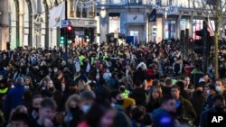 Crowds of shoppers walk under the Christmas lights in Regent Street, in London, Saturday, Dec. 12, 2020. Health Secretary Matt Hancock says infections are starting to rise in some areas after falling during a four-week national lockdown in England…