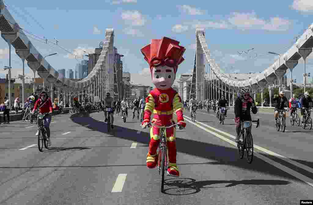 A cyclist wearing a costume of a cartoon character rides during the Cycling Festival in Moscow, Russia.
