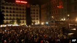 People attend a speech by Pablo Iglesias, leader of the Podemos (We Can) party celebrating the party results after the elections and in support of local candidate for Ahora Madrid (Madrid Now) party in Madrid, Spain, Sunday, May 24, 2015.