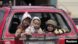 Children sit in a car in Benghazi, Libya. UNICEF says nearly 200,000 children in Libya need clean water, and more than 300,000 need educational support.