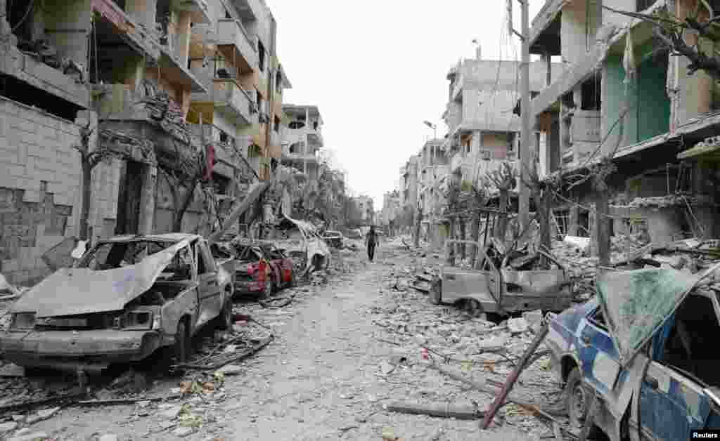 The damaged cars and buildings are seen in the besieged town of Douma, Eastern Ghouta, Damascus, Syria.