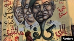 Mural depicts combination of the faces of former Egyptian president Mubarak and Field Marshal Tantawi, Cairo, June 14, 2012.