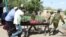 A man is transported on a stretcher after he was injured when a bus he was riding in drove onto a roadside bomb, near the Kenya-Somalia border in Mandera county, Kenya, Jan. 31, 2022. 