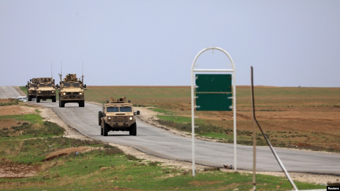 FILE - U.S. troops patrol near Turkish border in Hasakah, Syria, Nov. 4, 2018.