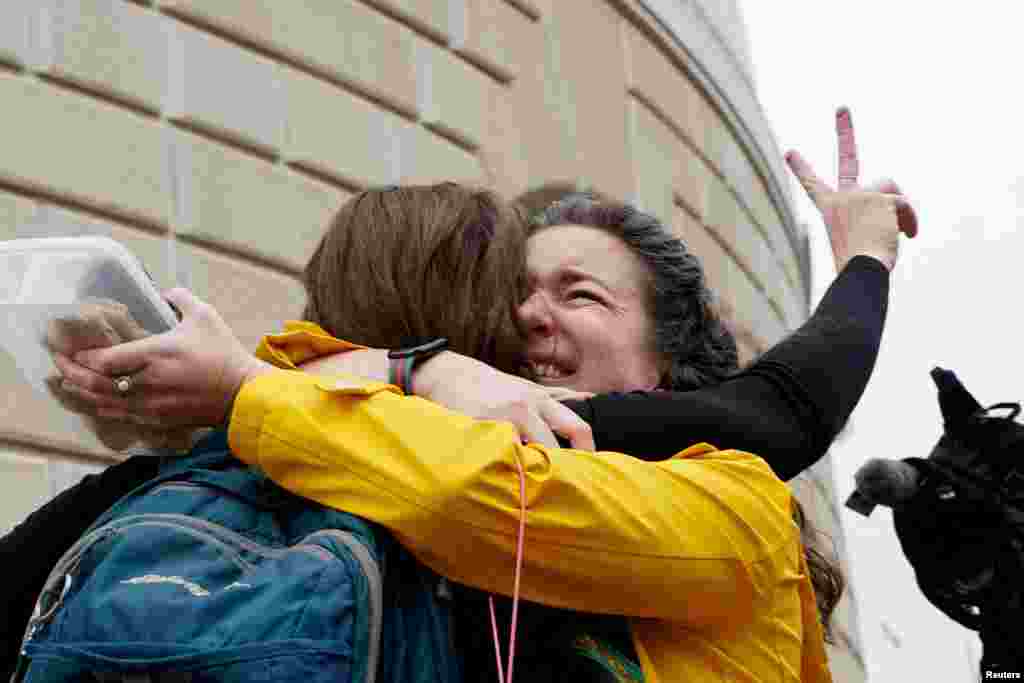 Terminated U.S. Agency for International Development (USAID) employee Caitlin Harwood hugs her cousin Samantha Kent after laid-off USAID workers cleared out their desks and collected personal belongings, during a sendoff in Washington.