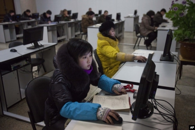 FILE - North Koreans work at computer terminals inside the Grand People's Study House in Pyongyang, North Korea, January 9, 2013.