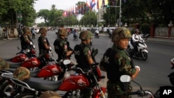 FILE: Riot police block a street near the Supreme Court in Phnom Penh, Cambodia, Tuesday, Oct. 31, 2017. The Supreme Court on Tuesday uphold the lower court's decision to continue to detain opposition leader Kem Sokha who has been charged with treason, the latest in a series of moves to gain an advantage ahead of 2018 general election. (AP Photo/Heng Sinith)