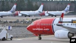 FILE - Boeing 737-800 aircraft belonging to budget carrier Norwegian are parked at Stockholm Arlanda Airport, March 5, 2015.