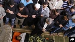 Palestinians pray over the bodies of four Islamic Jihad militants killed in Israeli airstrikes Saturday, during his funeral in Gaza City, Sunday, Oct. 30, 2011