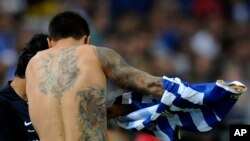 FILE - The tattoos from FC Porto's player Juan Manuel Iturbe, from Argentina, are seen during their match with Maritimo in a Portuguese League soccer match at the Dragao Stadium in Porto, Portugal, Sunday, Aug. 25, 2013. (AP Photo/Paulo Duarte)